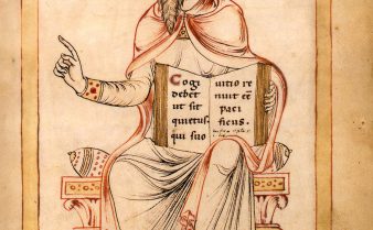Pintura colorida do escritor e estadista romano Cassiodoro. Ele tem barba longa, usa um adereço na cabeça e está sentado com um livro em sua mão esquerda.